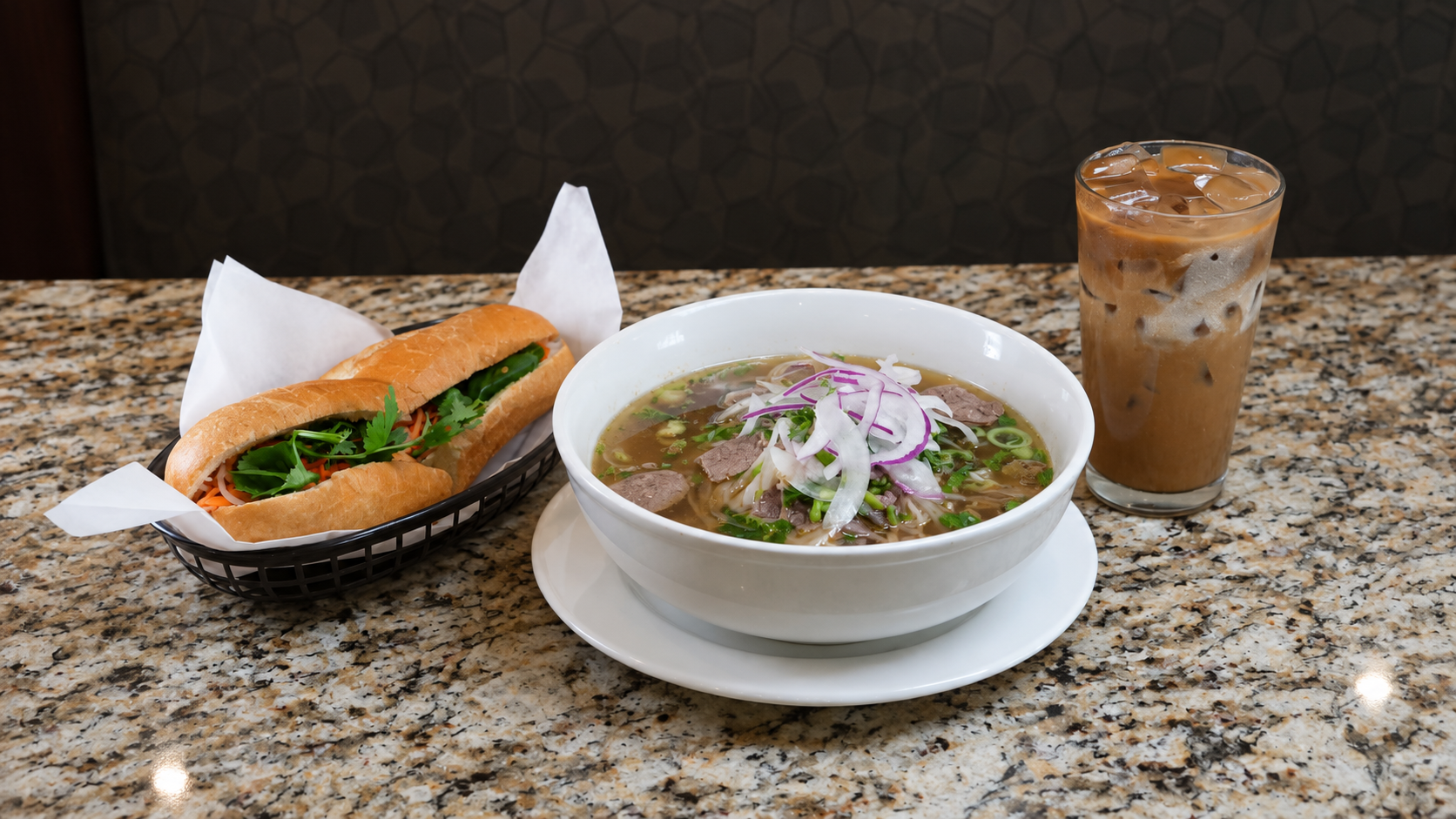 Phở bowl with bánh mì and Vietnamese iced coffee